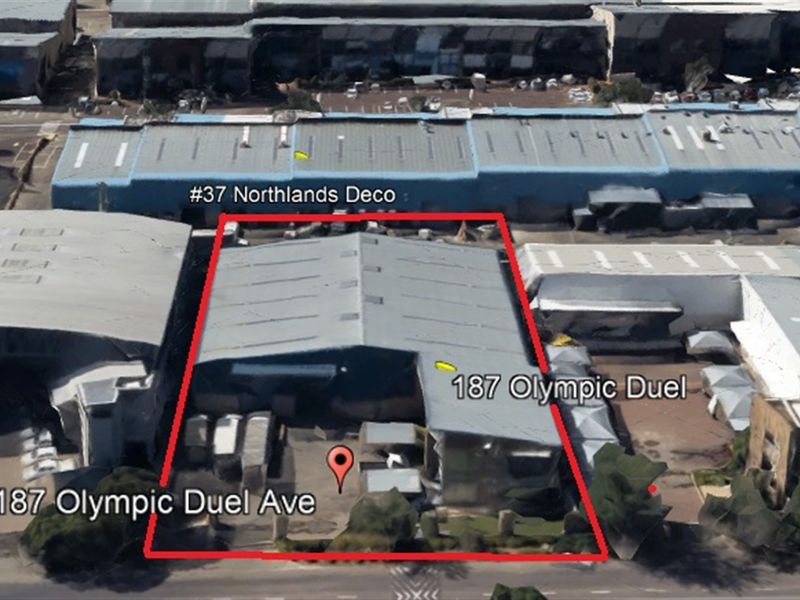 Aerial view of the industrial property located at 187 Olympic Duel Avenue, highlighting the warehouse structure and surrounding yard space.