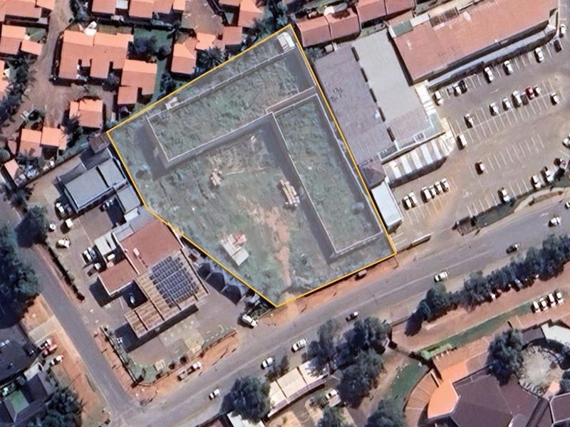 Aerial view of a commercial property site, highlighting the land boundary and surrounding urban infrastructure.