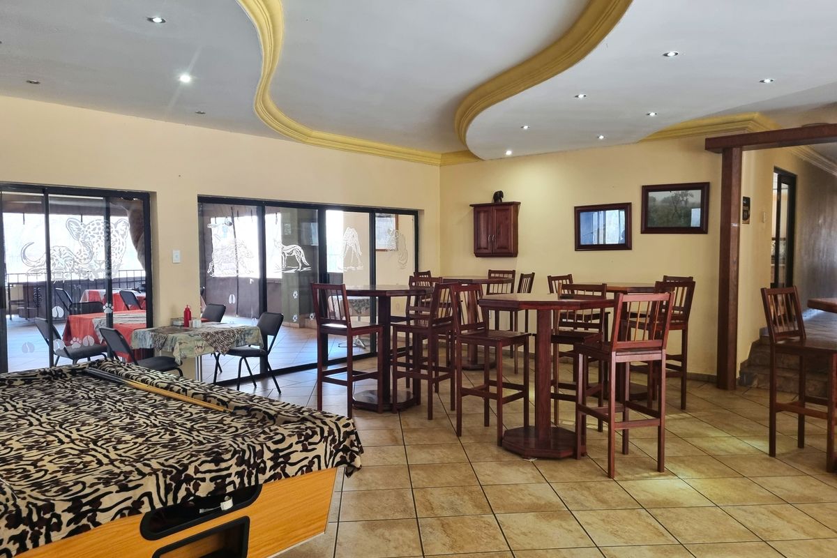 Spacious living area featuring decorative bulkhead ceilings, recessed lighting, and large sliding glass doors leading to an outdoor patio space.