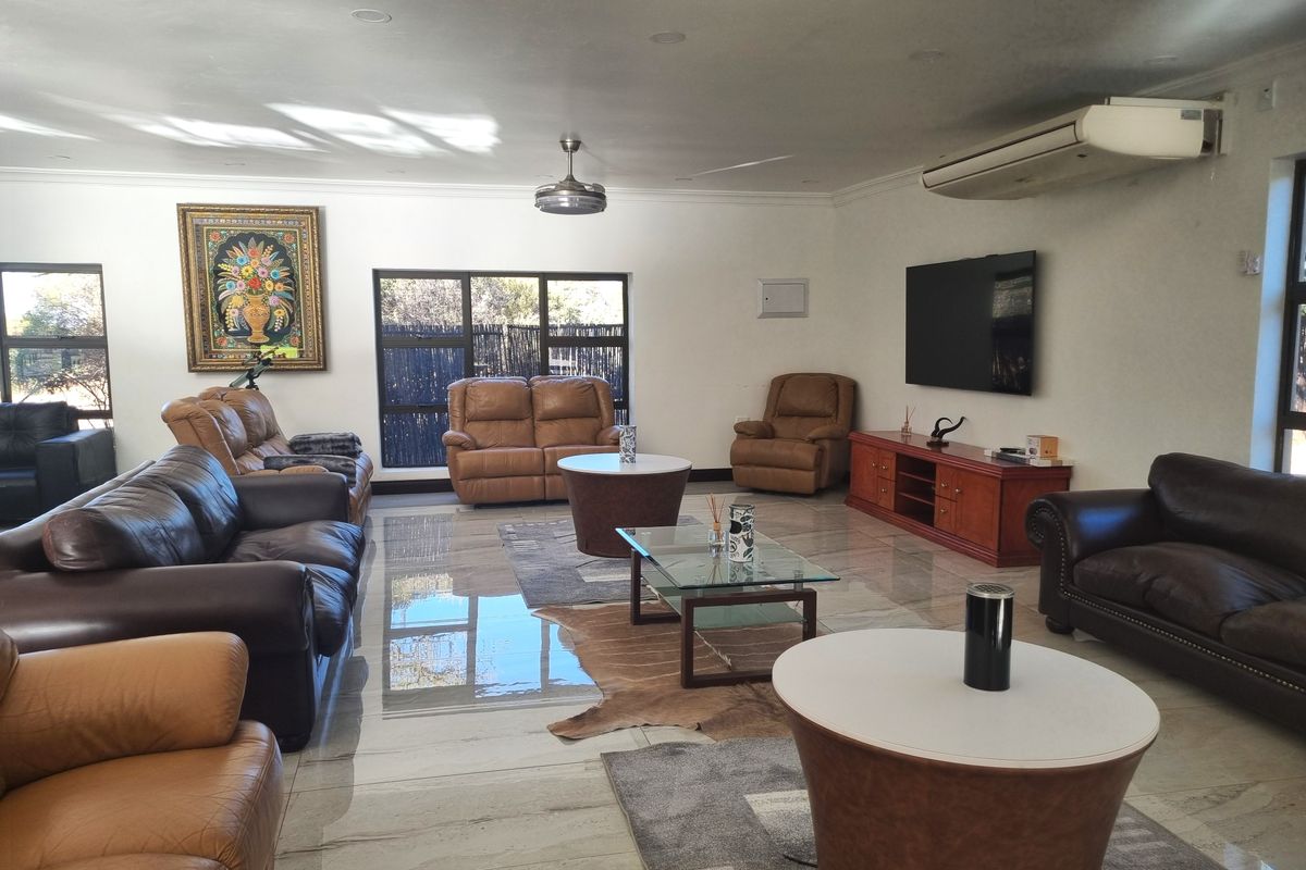 Spacious living room featuring polished tiled flooring, recessed lighting, a ceiling fan, and a wall-mounted air conditioning unit.