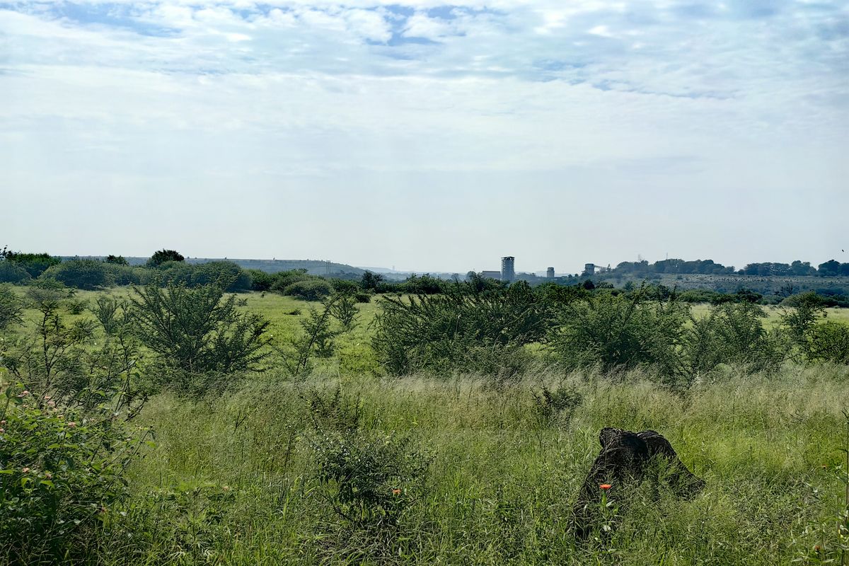 A wide-angle view of the expansive rural landscape and natural vegetation surrounding the property.