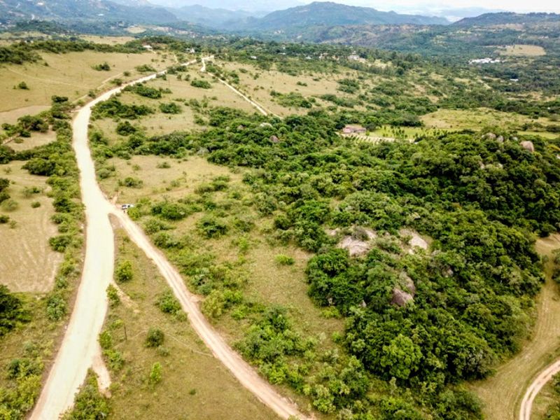 An aerial view of the small holding property showcasing the expansive natural landscape, indigenous vegetation, and access roads.