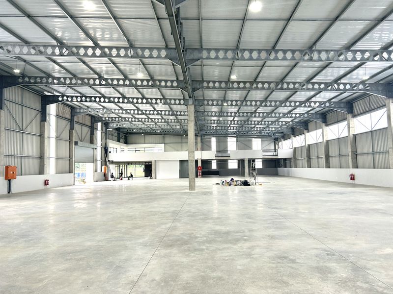 Spacious industrial warehouse featuring a high-clearance steel portal frame, polished concrete flooring, and a mezzanine level, suitable for various commercial or storage operations.