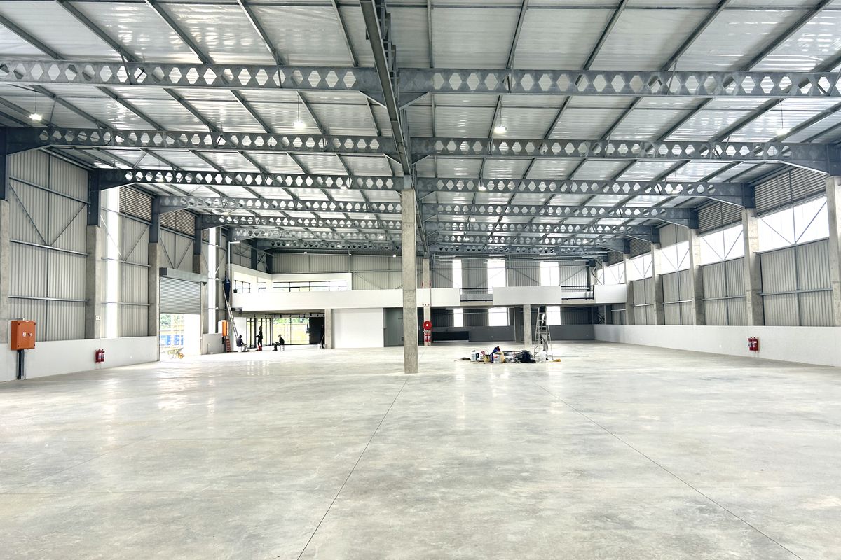 Spacious industrial warehouse featuring a high-clearance steel portal frame, polished concrete flooring, and a mezzanine level, suitable for various commercial or storage operations.