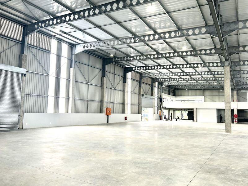 Spacious industrial warehouse featuring high ceilings, steel portal frame construction, polished concrete flooring, and a mezzanine level suitable for storage or office conversion.