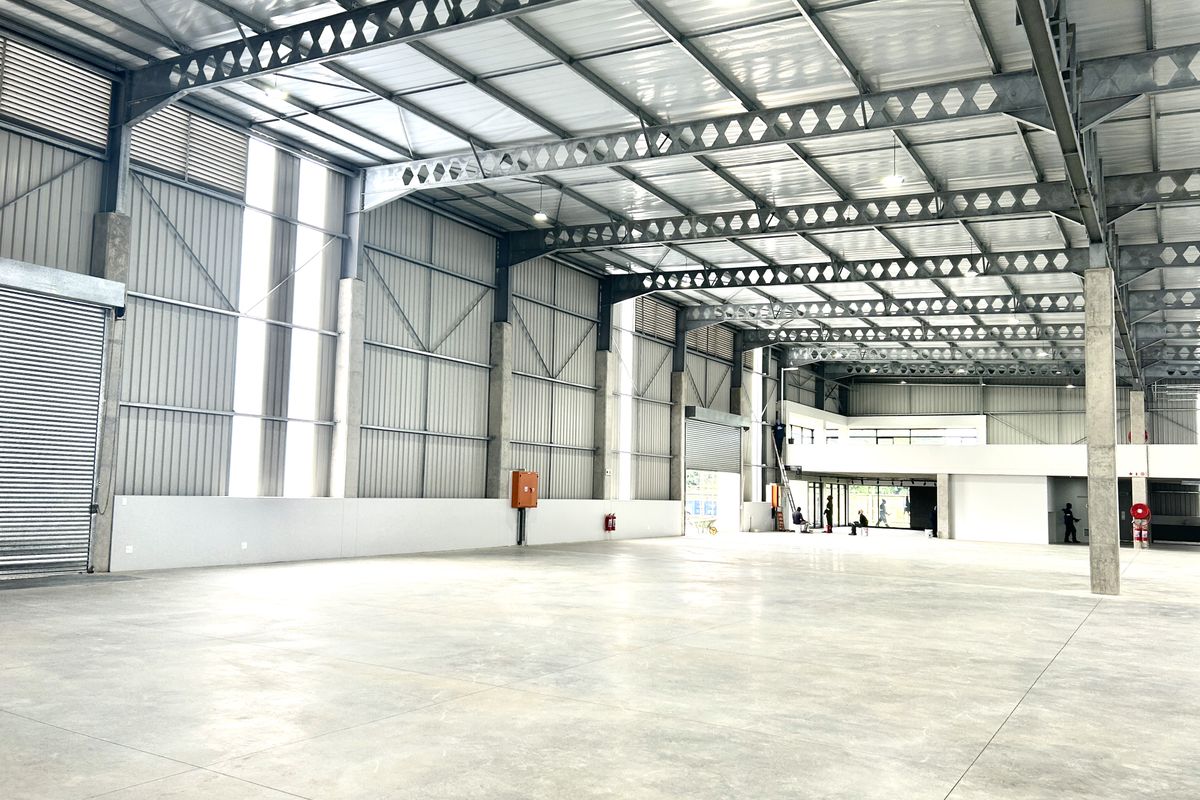 Spacious industrial warehouse featuring high ceilings, steel portal frame construction, polished concrete flooring, and a mezzanine level suitable for storage or office conversion.