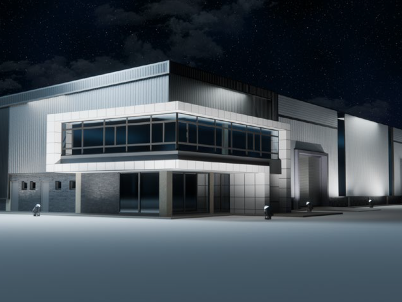 Modern industrial warehouse facility featuring metal cladding, extensive glazing, and integrated roller shutter doors, presented in a professional night-time architectural render.