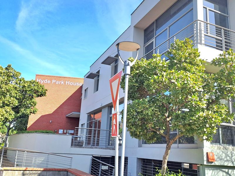 Exterior view of Hyde Park House office building featuring modern architectural design, large glass windows, and brick facade elements.