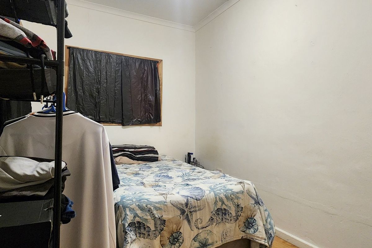 A compact bedroom featuring plain walls, coving, and skirting boards, currently utilized as a sleeping area.