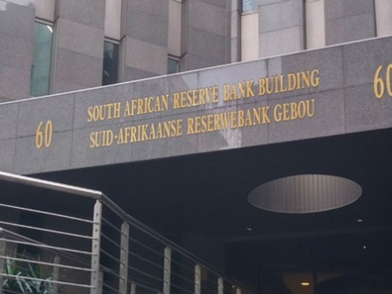 The main entrance facade of the South African Reserve Bank building, featuring polished granite cladding and modern stainless steel architectural detailing.