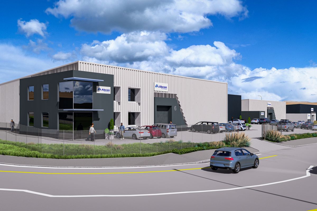 A modern industrial warehouse complex featuring contemporary facade design, large roller shutter doors, and paved parking areas, presented as a professional architectural rendering.