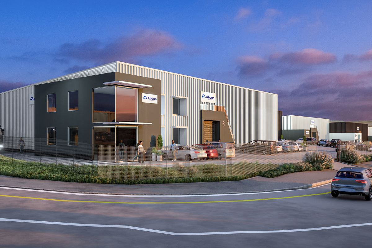 A modern industrial warehouse complex featuring corrugated metal cladding, large roller shutter doors, and professional landscaping, presented as a high-quality architectural rendering.
