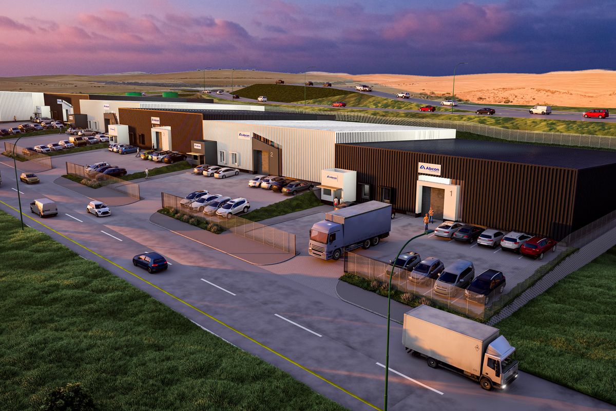 Aerial view of a modern industrial park featuring multiple warehouse units with roller shutter doors, paved parking areas, and secure perimeter fencing.