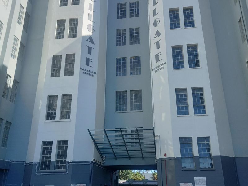 Front elevation of the Tollgate Industrial Centre, featuring a multi-story facade with a glass entrance canopy and dedicated parking area.