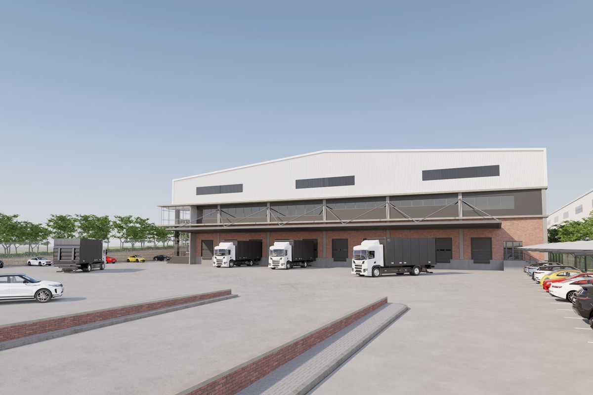 A modern industrial warehouse facility featuring multiple loading bays, a spacious paved yard, and dedicated covered parking areas.