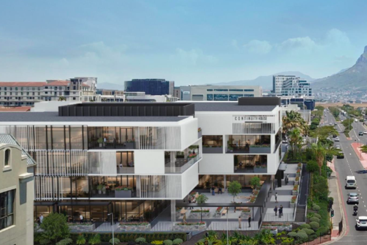 Aerial view of a modern multi-story office building featuring contemporary architectural design, glass facades, and integrated landscaped outdoor spaces.