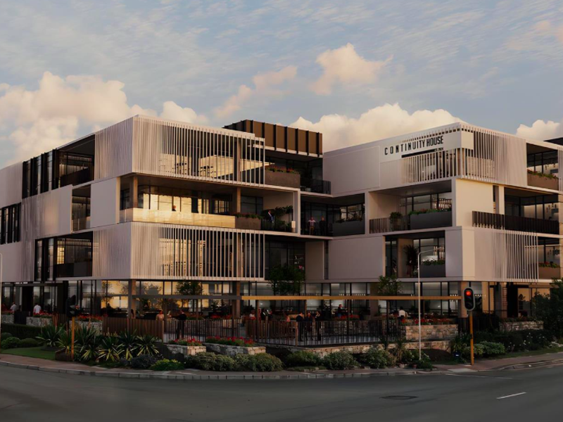 A modern multi-story office building featuring contemporary architectural design, glass facades, integrated balconies, and professional landscaping at the street level.