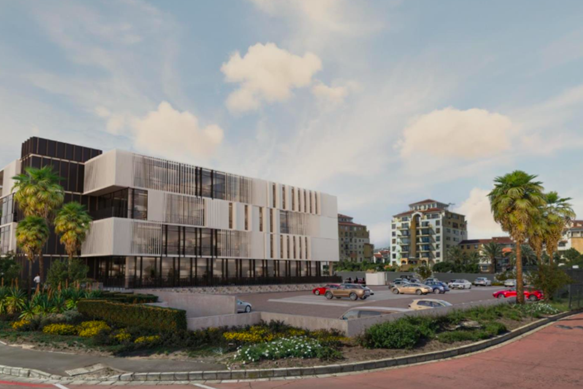 A modern multi-story office building featuring a contemporary facade with glass curtain walls and vertical louvers, complemented by a paved parking area and landscaping.