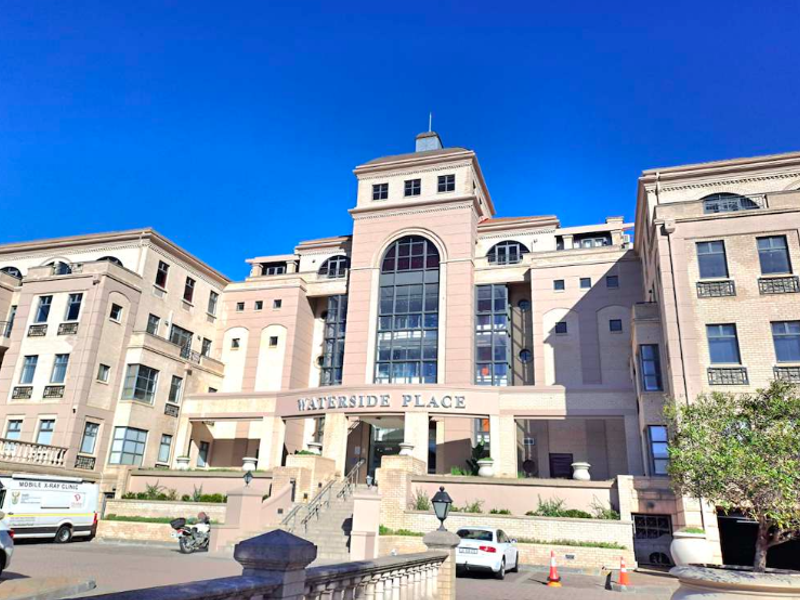 A professional exterior view of the Waterside Place office building, featuring a multi-story facade with stone detailing and a prominent central entrance.