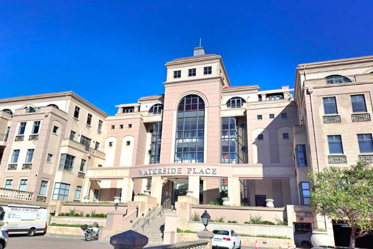 A professional exterior view of the Waterside Place office building, featuring a multi-story facade with stone detailing and a prominent central entrance.