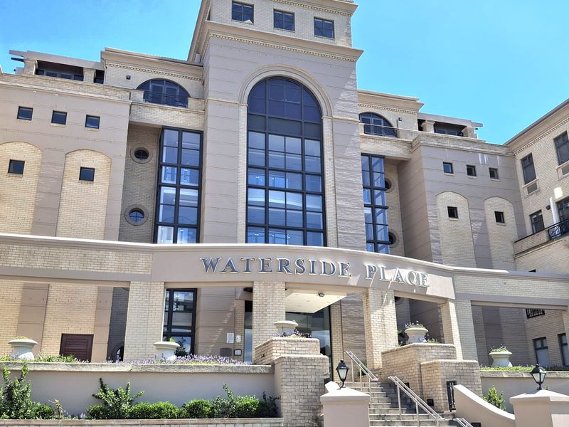 Front elevation of Waterside Place office building featuring a prominent arched window, brick facade, and a grand stone staircase entrance.