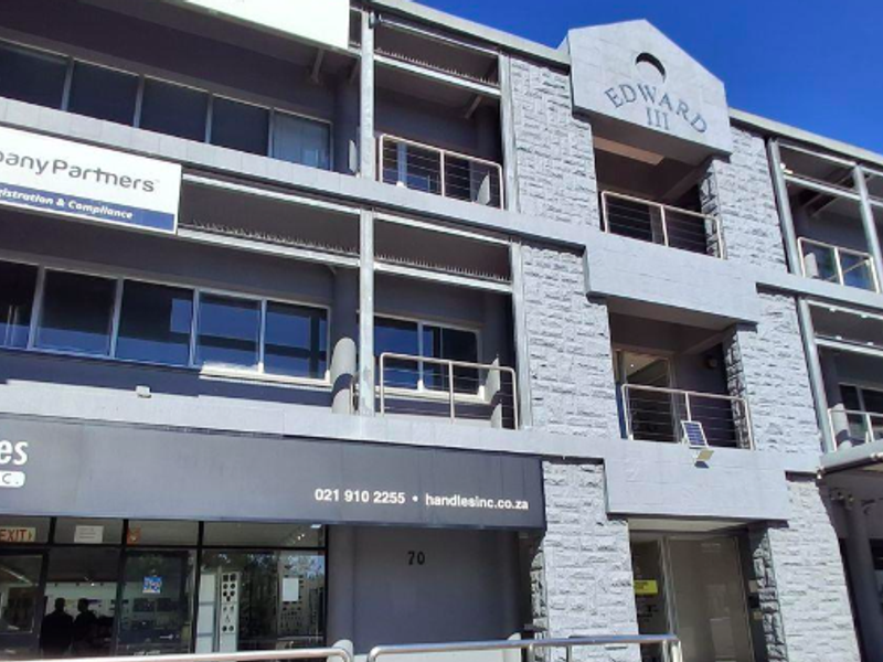 Front elevation of the Edward III office building featuring stone cladding, large glass windows, and prominent commercial signage for multiple tenants.