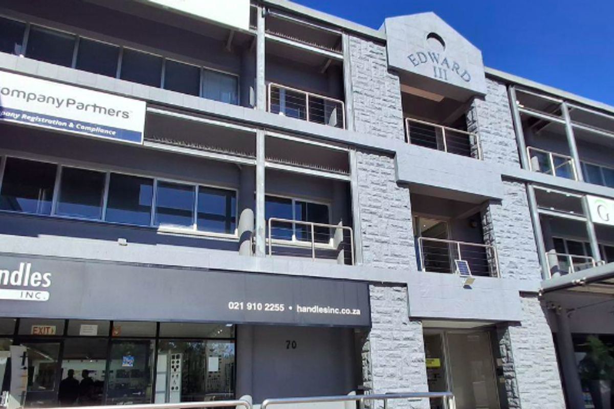 Front elevation of the Edward III office building featuring stone cladding, large glass windows, and prominent commercial signage for multiple tenants.
