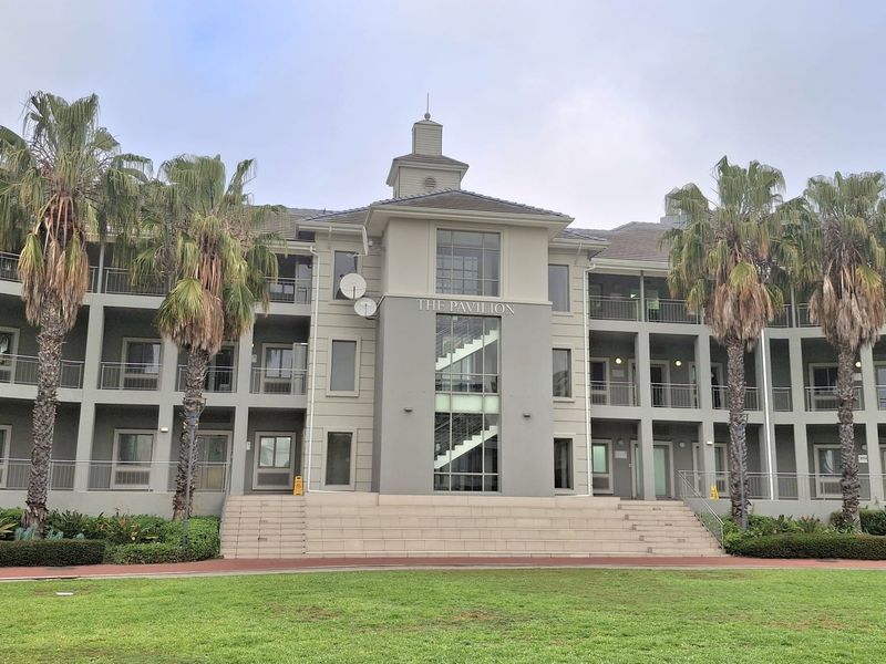 Front elevation of The Pavilion office building featuring a multi-story facade, central staircase, and balcony access.