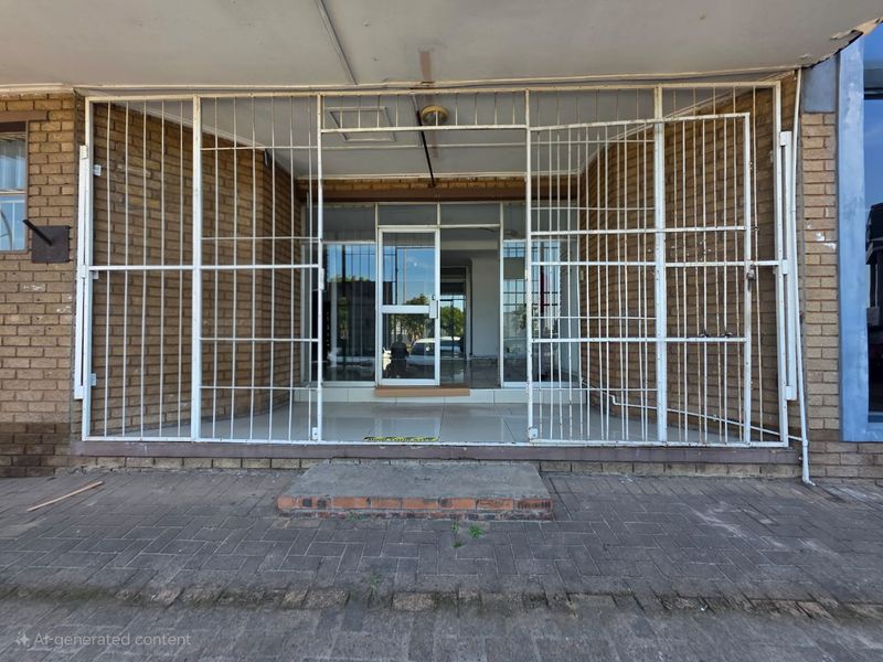 Front entrance of a commercial property featuring a brick facade, glass door, and protective security gate.