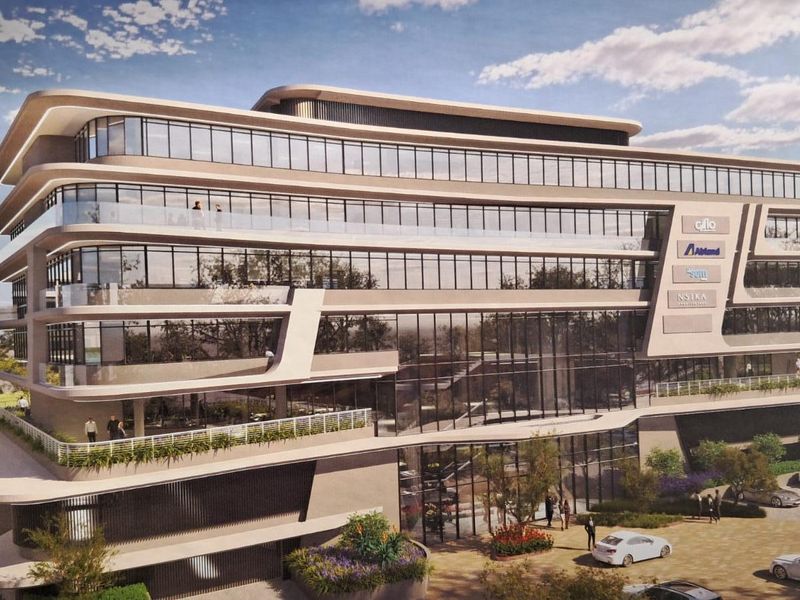 A modern multi-story office building featuring extensive glass curtain walls, wrap-around balconies, and contemporary architectural design.