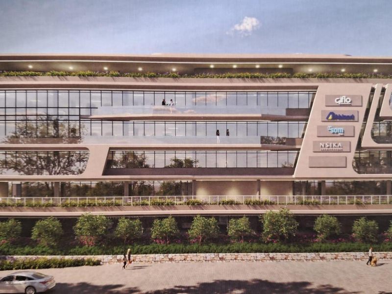 A modern multi-story office building featuring extensive glass curtain walls, integrated balconies, and professional signage, showcasing contemporary architectural design.