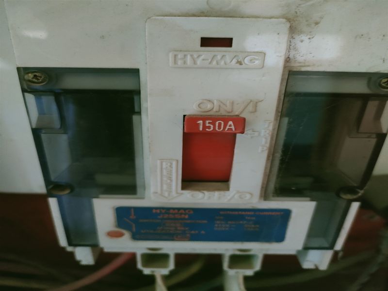 A close-up view of a 150A industrial circuit breaker unit, showing the main power switch and technical specifications.