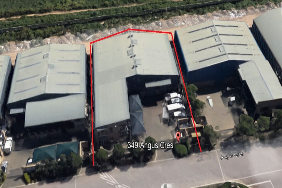 Aerial view of an industrial warehouse property located on Angus Crescent, featuring a metal roof and paved yard space.