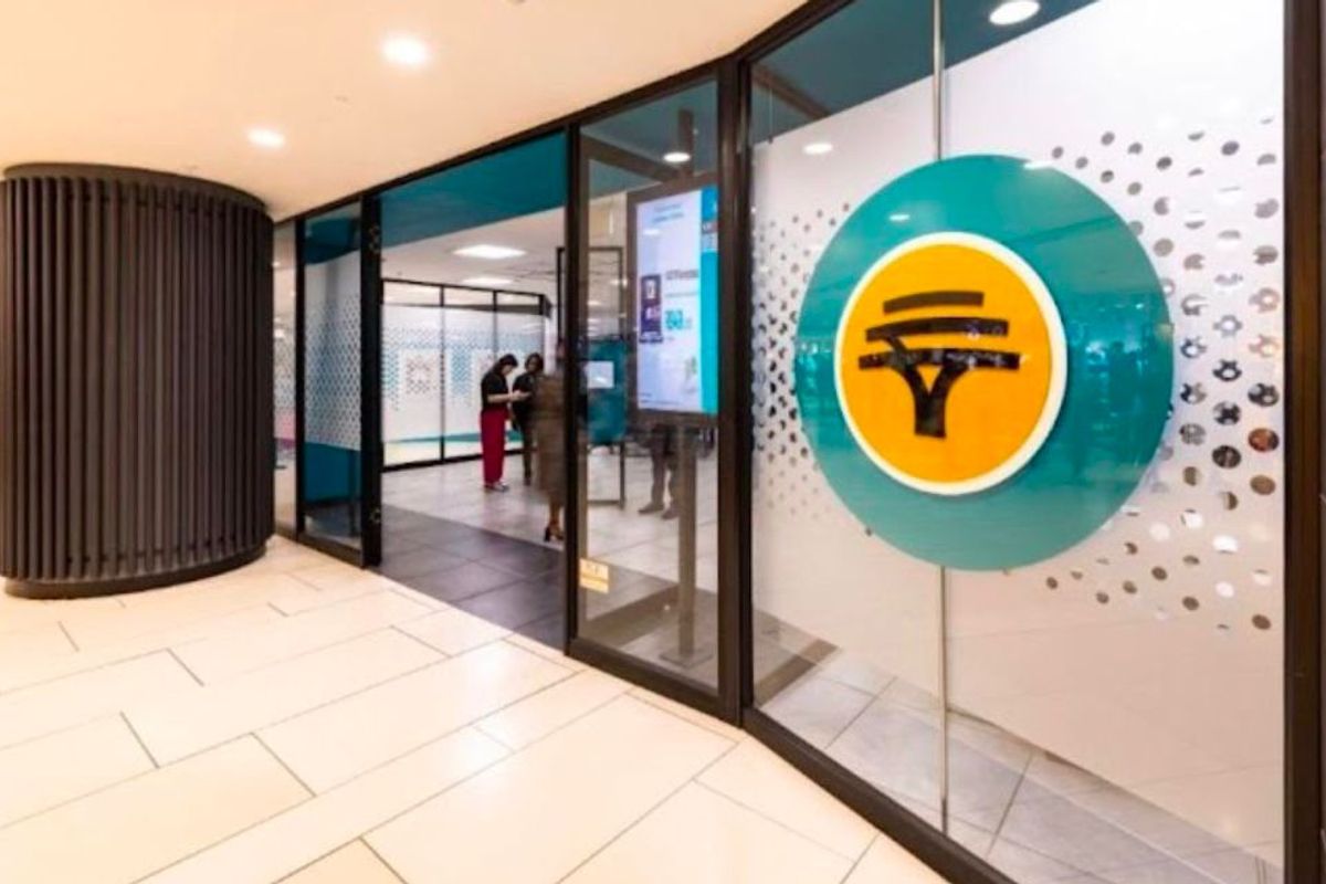 Modern retail entrance featuring a glass storefront, professional branding, recessed lighting, and high-quality tiled flooring in a well-maintained commercial space.