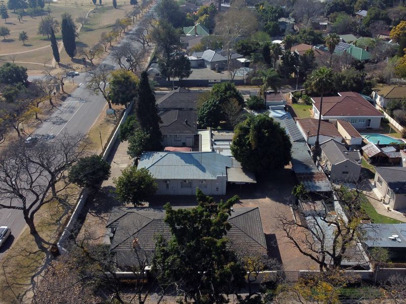 Aerial view of the office property showing the building layout, roof structures, and surrounding site access from the adjacent road.