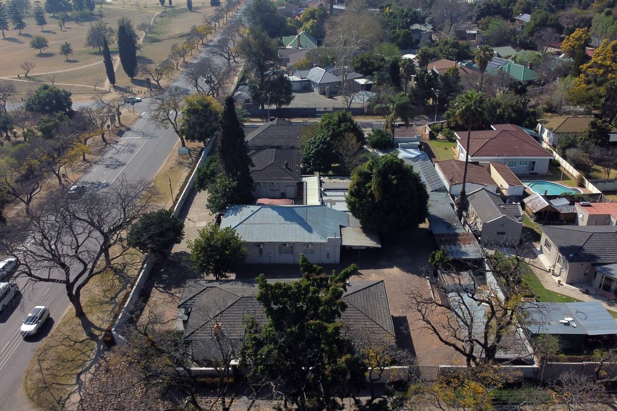 Aerial view of the office property showing the building layout, roof structures, and surrounding site access from the adjacent road.