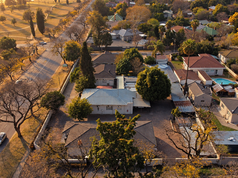 Aerial view of the office property showing multiple buildings, paved parking areas, and surrounding residential neighborhood infrastructure.