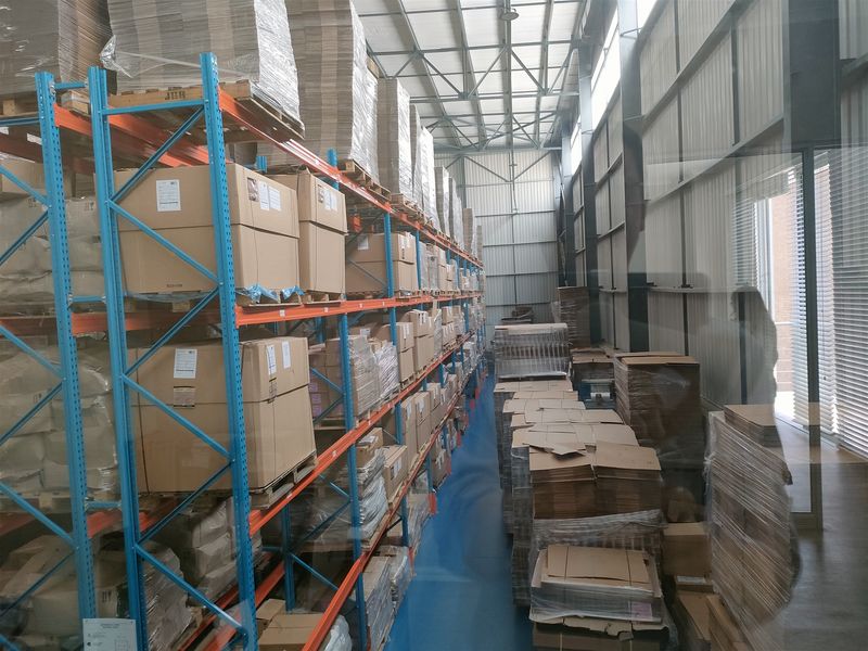 Industrial warehouse space featuring high-capacity steel racking systems, durable epoxy flooring, and a clear-span steel portal frame structure.