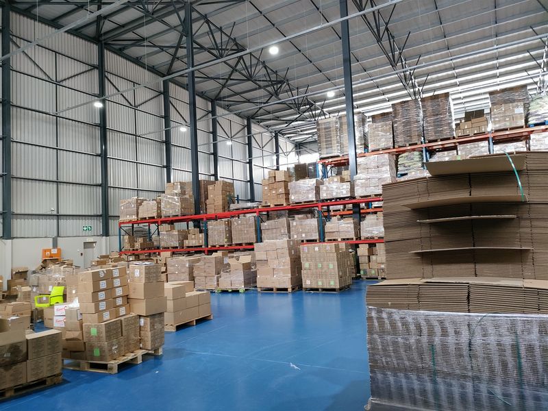 Spacious industrial warehouse featuring high-clearance steel portal frame construction, durable epoxy-coated flooring, and extensive integrated pallet racking systems for efficient storage.