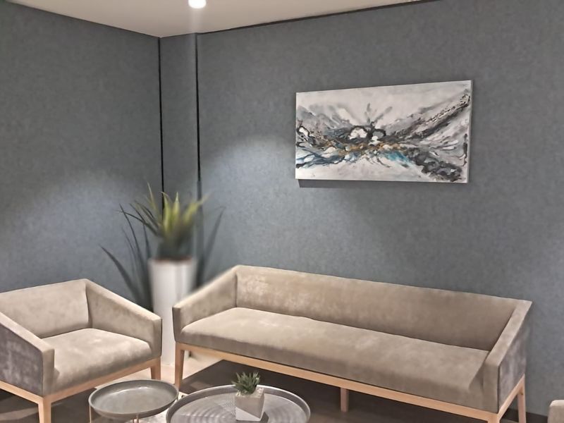 A professional office waiting area featuring modern textured walls and recessed downlighting, creating a sophisticated and welcoming atmosphere for clients.