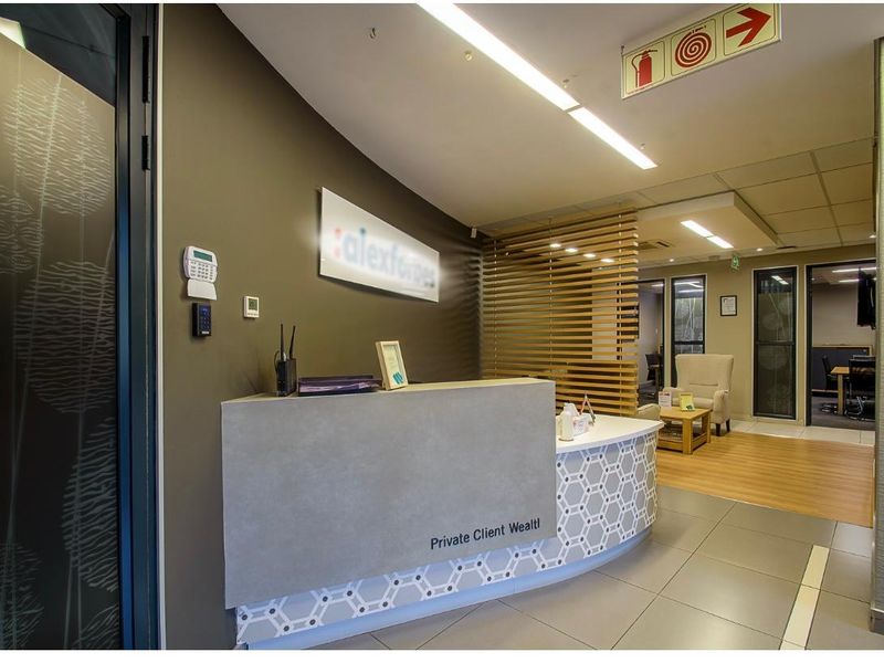 Professional office reception area featuring a modern custom reception desk, slatted timber room divider, and integrated security systems.