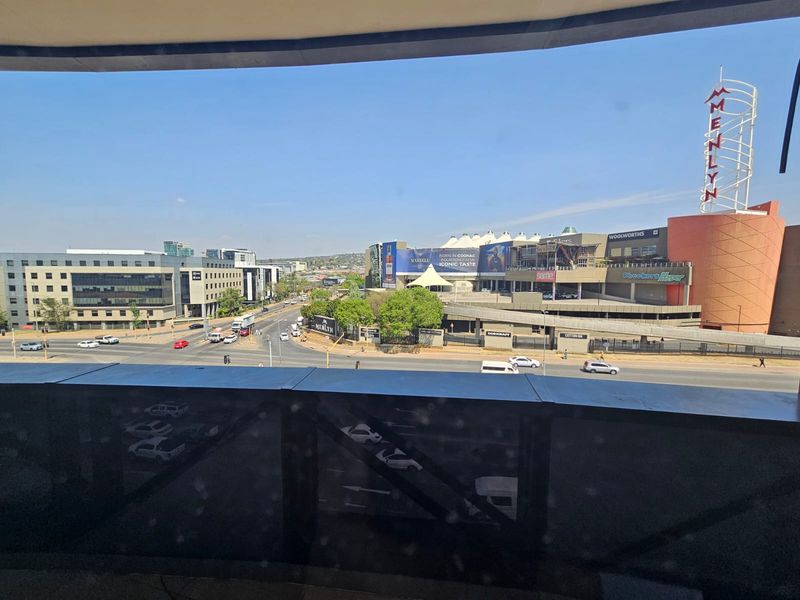 Elevated urban view overlooking a major intersection and the Menlyn shopping center complex.
