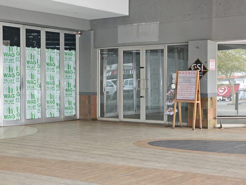 Retail storefront entrance featuring glass doors and tiled flooring, currently vacant and available for lease.