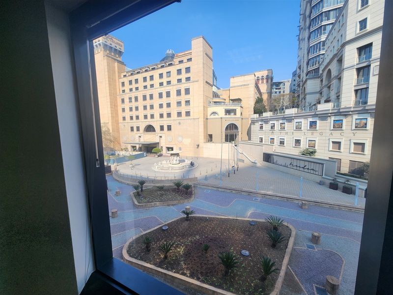A clear view of the surrounding urban plaza and architectural buildings from an office window.