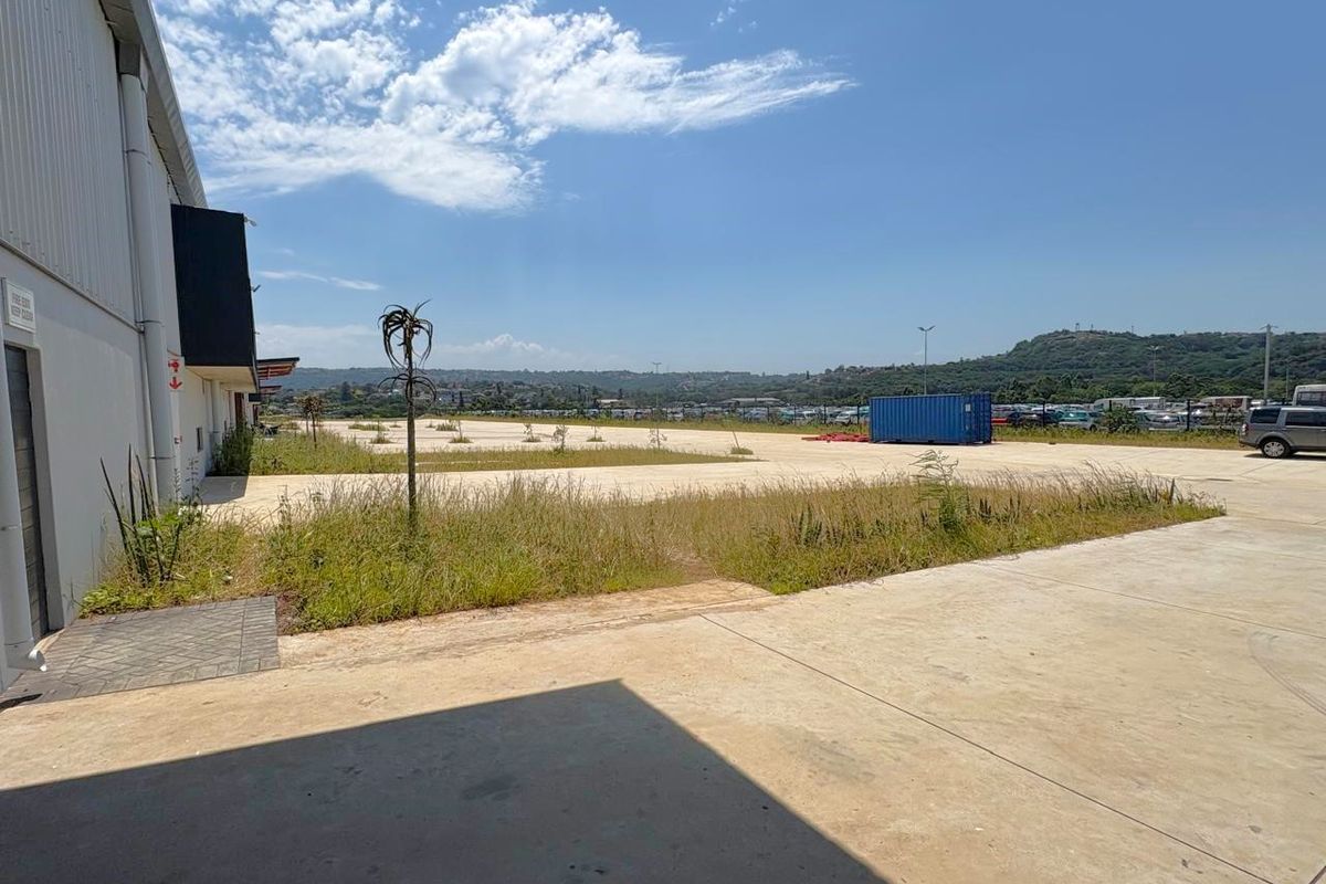 Expansive industrial yard area featuring concrete hardstand, perimeter fencing, and open space suitable for vehicle access or outdoor storage.