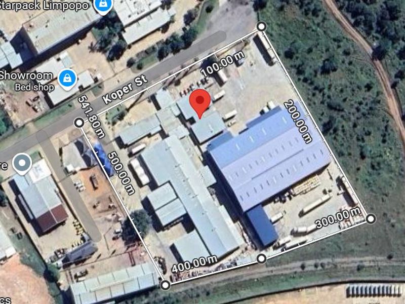Aerial view of an industrial property featuring multiple warehouse structures and a large yard area with perimeter access.