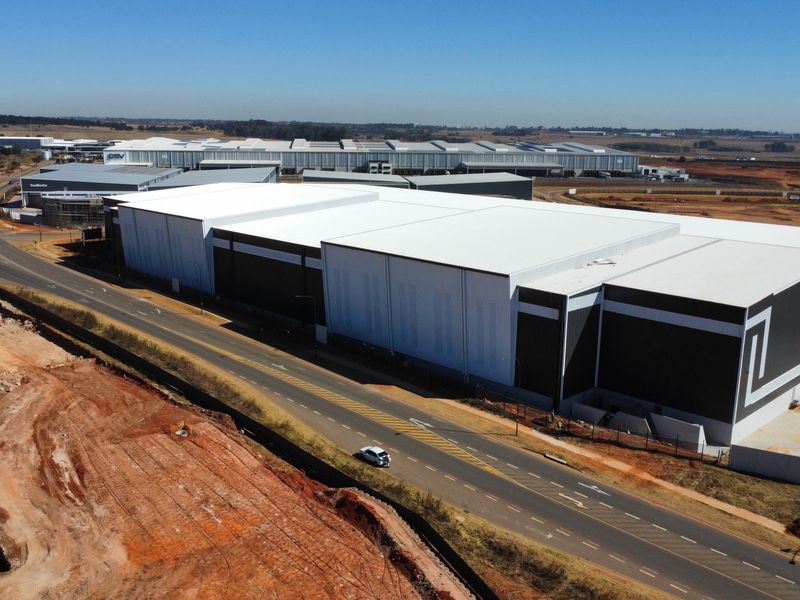 Aerial view of a large modern industrial warehouse facility with extensive site access and surrounding infrastructure.