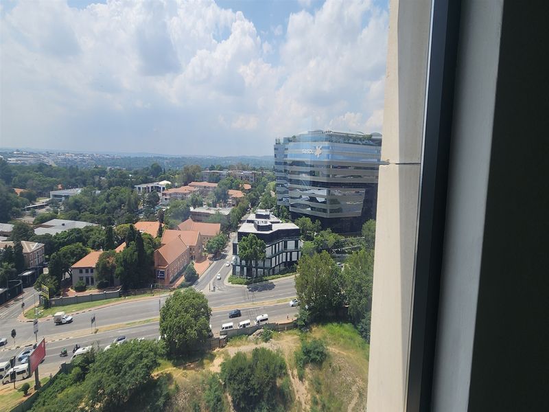An elevated urban view looking out from an office window over the surrounding neighbourhood and commercial buildings.