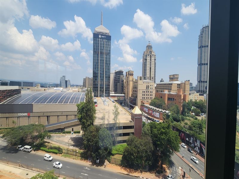 Elevated urban view overlooking the Sandton City skyline and surrounding commercial infrastructure.