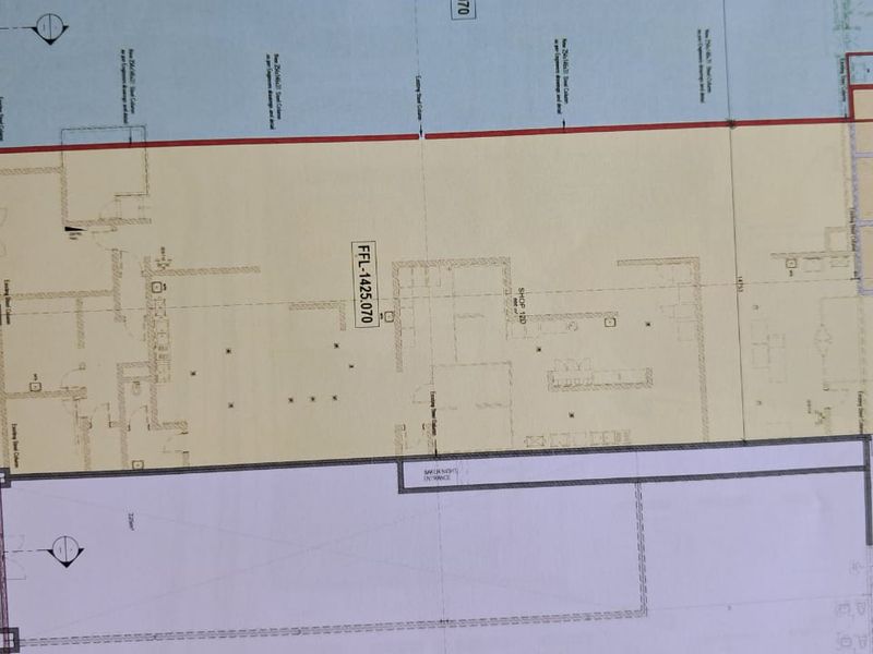 Architectural floor plan detailing the layout of the retail space, including structural columns, ramp access, and designated shop areas.